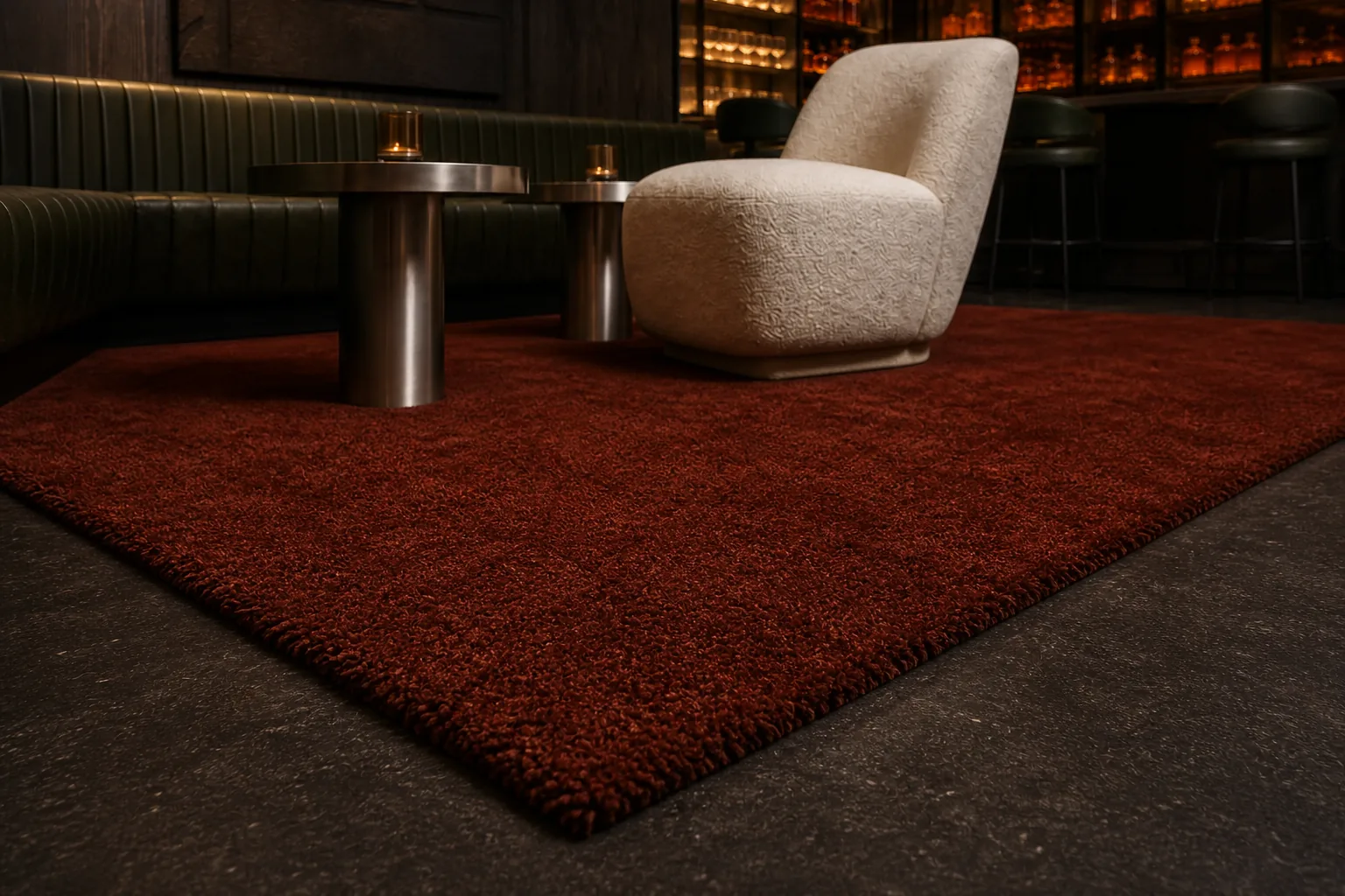 A brick-toned MAJLIS rug in a warm hospitality lounge with cream seating.